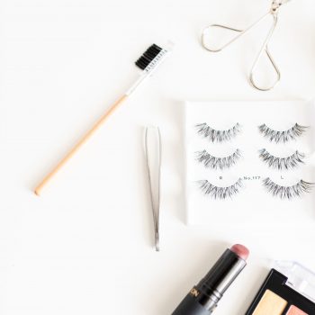 makeup flat lay eyelashes tweezers lipstick eyelash curler